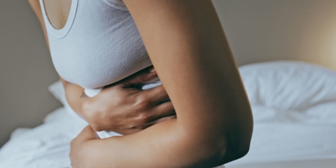 Woman with abdominal pain and going to seek treatment at Quality Care ER.