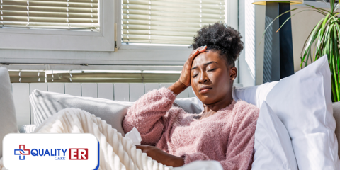 Lady in bed holding her head