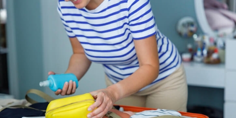 woman packing sunscreen