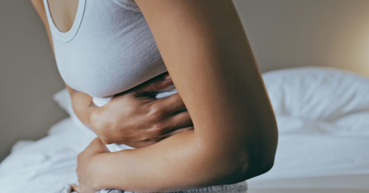 Woman with abdominal pain and going to seek treatment at Quality Care ER.