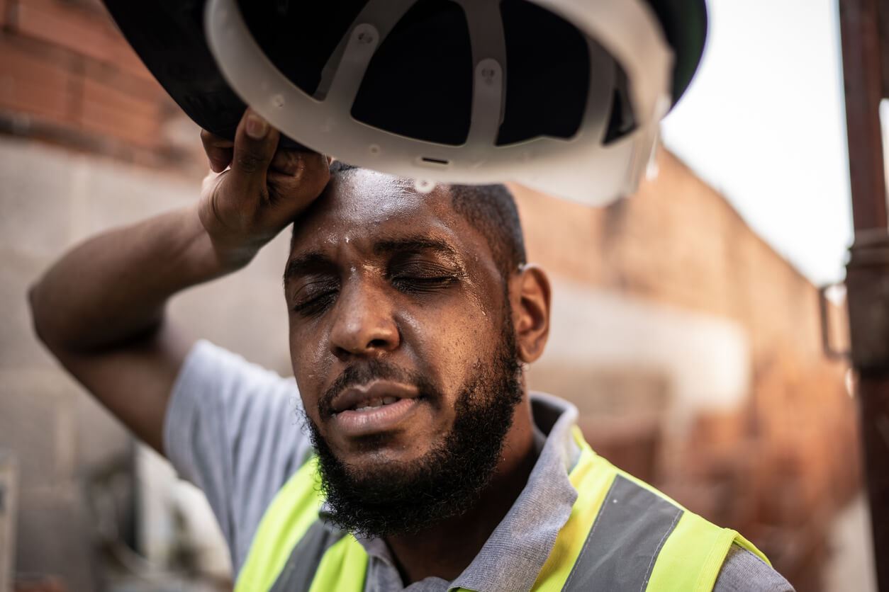 Exhausted construction worker at construction site.