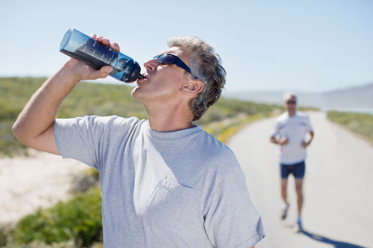 Thirsty man drinking water from water bottle