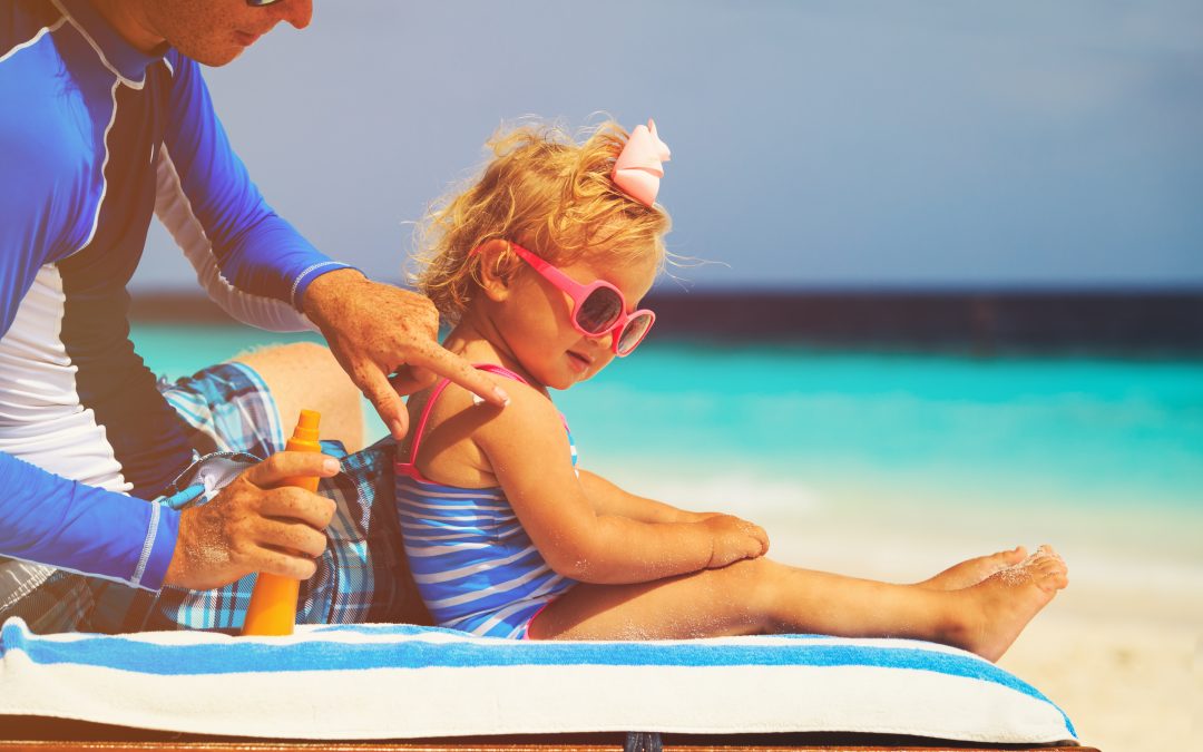 Toddler getting sunscreen